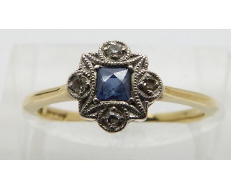 An 18ct gold ring set with a square cut sapphire and diamonds in a platinum setting, size K