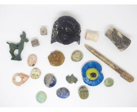 A quantity of ancient Roman and near Eastern artefacts, amulets including head, bronze ibex, gaming pieces