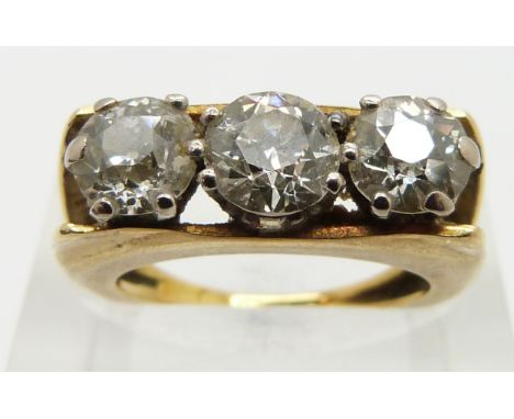 An 18ct gold ring set with three round cut diamonds each approximately 0.9, 0.7 and 0.7ct respectively, size K