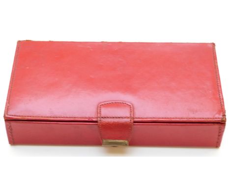 A red leather cased Bridge set including four hallmarked silver pencils mounted with playing card / dice finials.