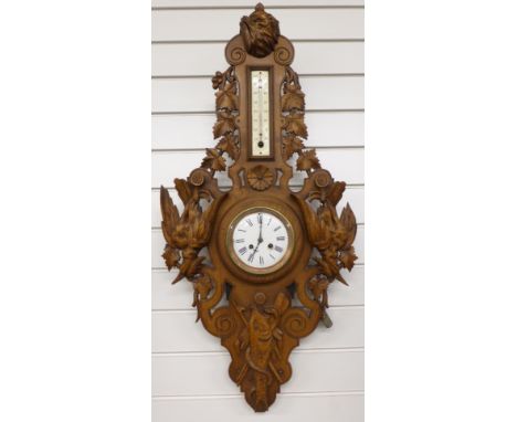 Late nineteenth / early twentieth century black forest carved wall clock / thermometer compendium. The enamelled roman dial w