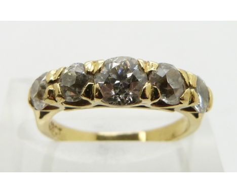 An 18ct gold ring set with five graduated round cut diamonds, the centre diamond approximately 0.7ct, size K