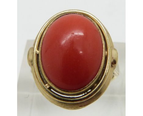 A 9ct gold ring set with a coral cabochon, size K
