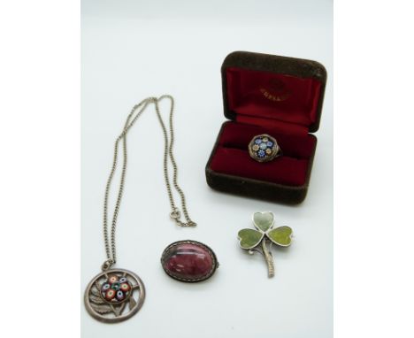 A silver pendant set with a millefiori cabochon by Caithness, a similar ring, a silver clover brooch set with serpentine and 