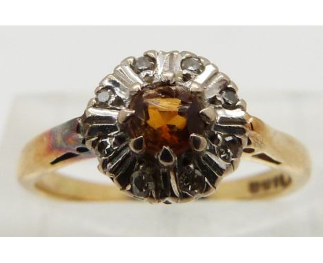 An 18ct gold ring set with a citrine and diamonds, size K