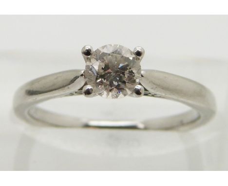 A platinum ring set with a round brilliant cut diamond of approximately 0.5ct, size K