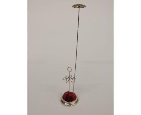 A silver hat pin stand, Chester 1921, together with a vintage hat pin.&nbsp;