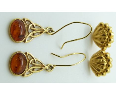 A pair of yellow metal earrings in the form of shells and a pair of 9ct gold earrings set with pressed amber