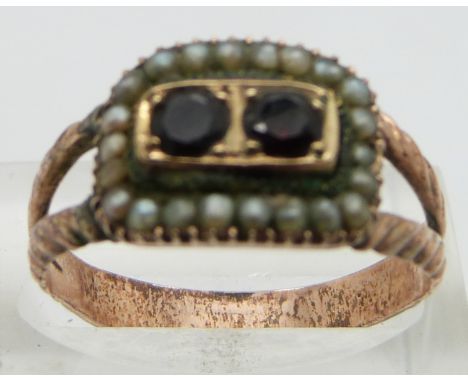 A Georgian ring set with seed pearls and two garnets in foiled setting with receipt, size Q/ R