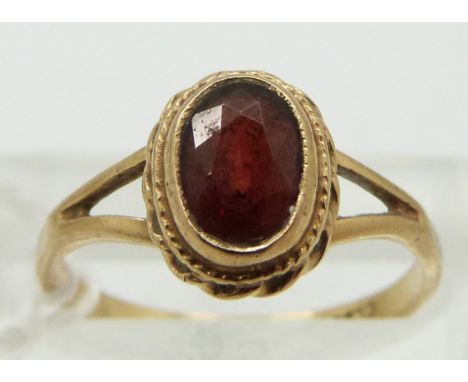 A 9ct gold ring set with a garnet, size K