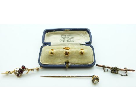 Three 9ct gold dress studs in fitted case, 9ct gold brooch set with an amethyst and seed pearls, 15ct gold brooch set with ga