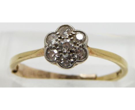 An 18ct gold ring set with diamonds in a cluster, size K