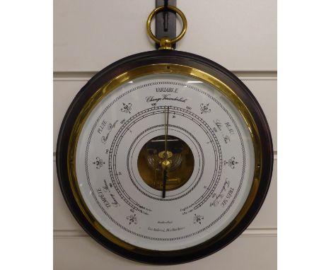 A circular 20thC aneroid barometer by Les Ateliers LM a Bordeaux, the white enamel dial with French, English and German predi
