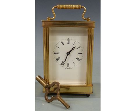 Twentieth century brass carriage clock by Lionel Peck of London, with white Roman dial and stylised Breguet hands, raised on 