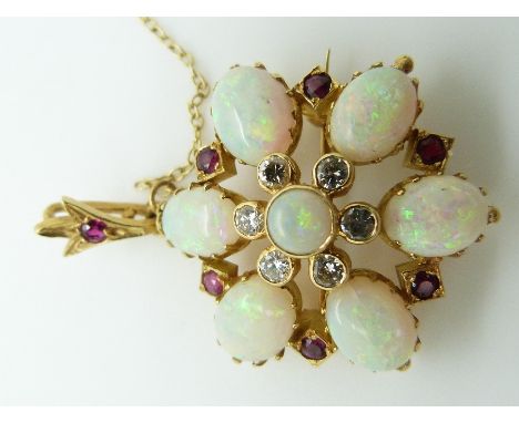 An 18ct gold pendant/ brooch set with seven opal cabochons, rubies and diamonds&nbsp;