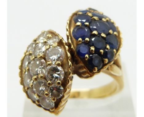 An 18ct gold ring set with diamonds and sapphires in two sections, the largest two stones approximately 0.2ct, size R