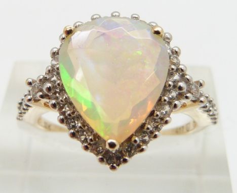 A 9ct gold ring set with a pear cut opal surrounded by white sapphires, size N