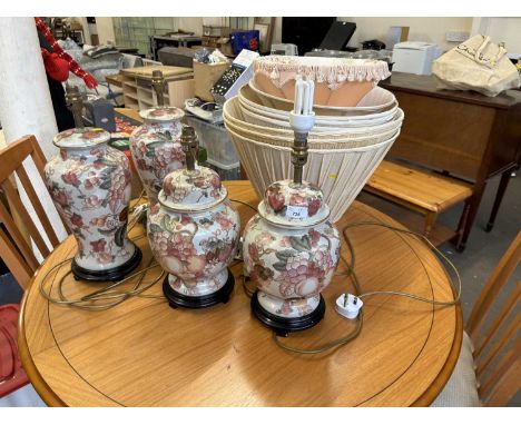 Two pairs of floral and gilt decorated ceramic lamps and a quantity of lampshades