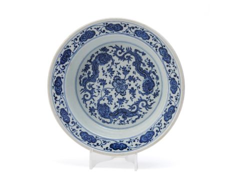 A Chinese blue and white 'Dragon' basin, 18th century, the interior painted with three dragons amongst scrolling foliage with
