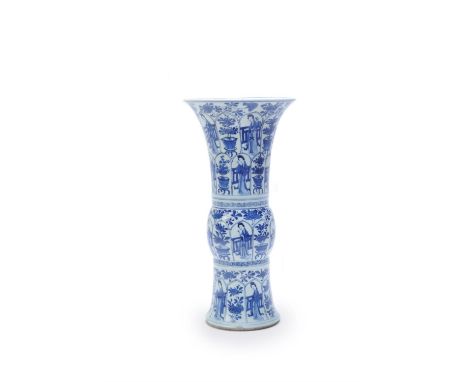 A Chinese blue and white vase, gu, Kangxi period (1662-1722), decorated with cartouches enclosing court ladies and flower pot