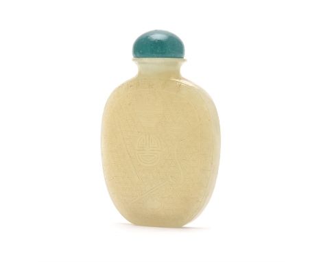 A Chinese pale celadon jade snuff bottle, Qing Dynasty, 19th century, of flattened ovoid form incised with central shou symbo