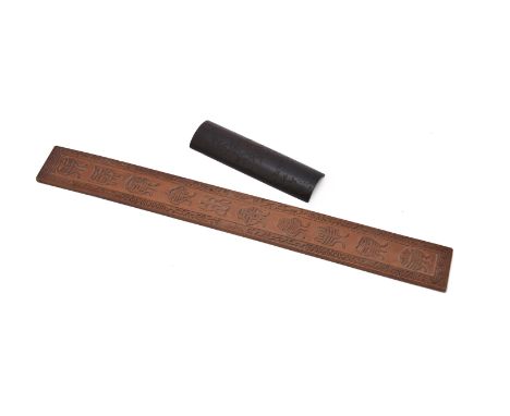 A Chinese ebony wood 'Pomegranate' wrist rest, late Qing/Republican period, carved with a pomegranate branch accompanied with