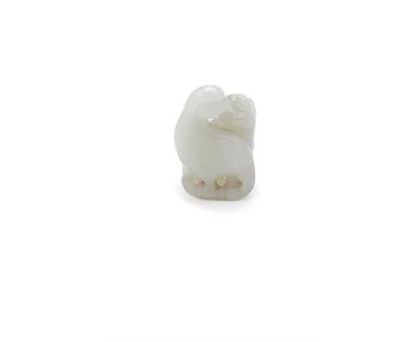 A Chinese pale celadon jade 'Phoenix and Lion' group, Qing Dynasty, carved and pierced with the two with heads touching and w