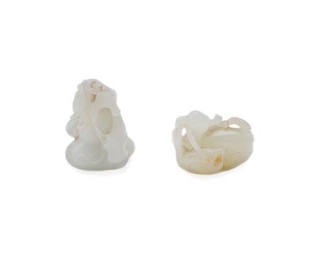 A Chinese white and russet jade 'Mandarin ducks' carving, 18th/19th century, Qing Dynasty, modelled as two ducks nesting, the