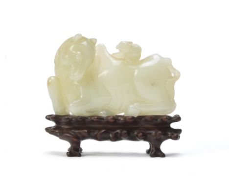 An unusual Chinese pale celadon jade 'horse and squirrel' belt buckle, Qing Dynasty, 18th century, well carved and the stone 