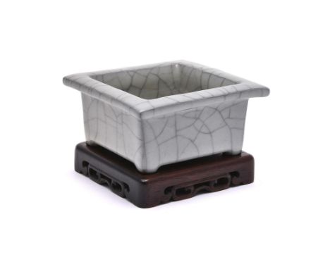 A Chinese guan-type square brush washer, Qing Dynasty, of shallow square form, covered in a thick greyish glaze suffused with