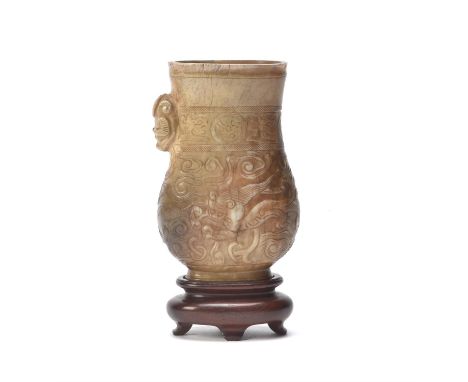 A Chinese 'Chicken bone' jade pouring vessel, zhi, Song-Ming Dynasty, the flattened pear-shaped body supported on a tall and 