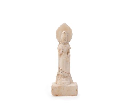 A small white marble Buddhist stele, Northern Qi Dynasty, the standing figure depicting Guanyin dressed in a lotus petal crow