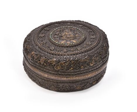 A copper-gilt 'Buddhist' openwork box, Tibet or Nepal, 19th century, of circular form, with chased and repoussé foliate relie
