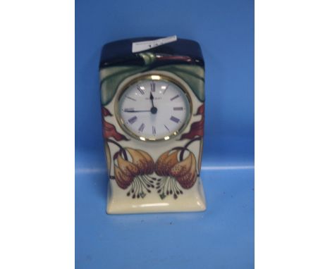 A MOORCROFT MANTEL CLOCK WITH FLOWER DECORATION