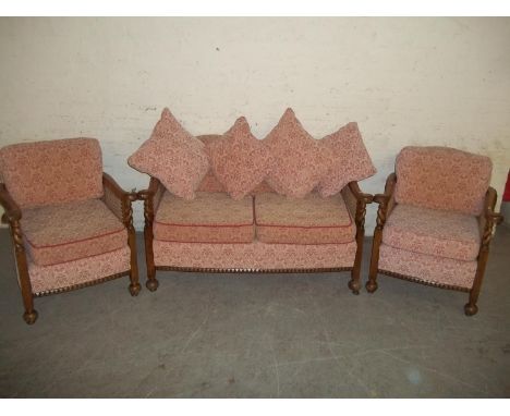 AN ANTIQUE THREE PIECE SUITE COMPRISING TWO SEATER SOFA AND TWO CHAIRS