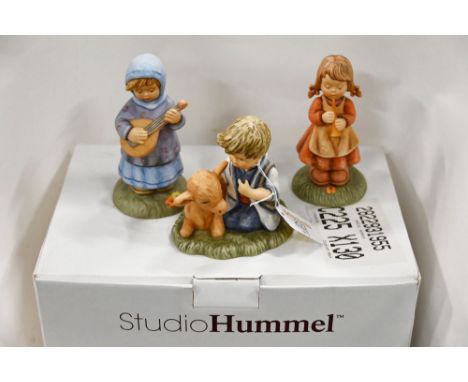 Three Goebel figurines, boy with calf, girl with lute and girl with recorder 