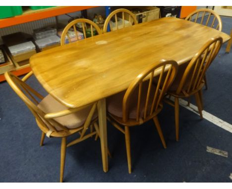 Ercol a light elm wood dining table and six chairs