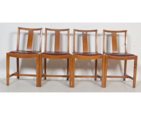 A set of four vintage mid 20th century oak dining chairs having a curved crest rail over a single back splat over a vinyl dro