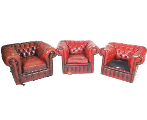 A group of three 20th century Oxblood leather chesterfield club armchairs. The arms with button backing to the leather uphols