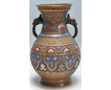 An early 20th century Meiji revival brass and enamel Cloisonne urn vessel having a waisted neck with dragon handles, polychro