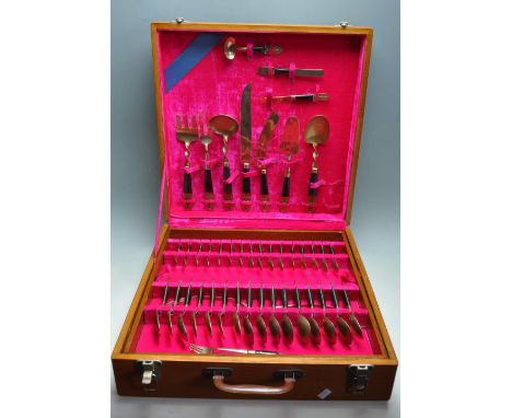 A 20th Century vintage Vietnamese / Siamese cutlery canteen 140 pieces .appointed with gilt cutlery having dark wood handles 