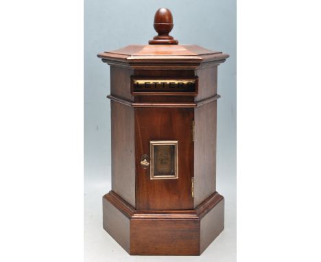 An antique style Victorian Revival mahogany post box having a finial top with a brass letters flap within a hexagonal shaped 