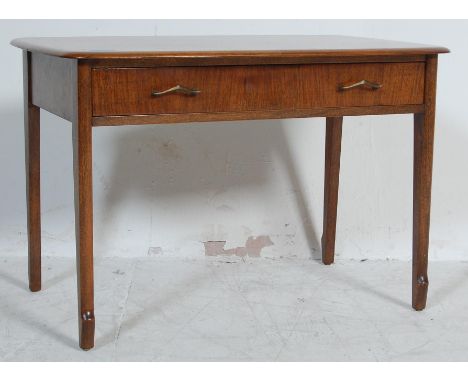 A vintage retro 20th century Remploy teak wood coffee table of a rectangular form raised on shaped legs.
Measures 46 cm H x 7