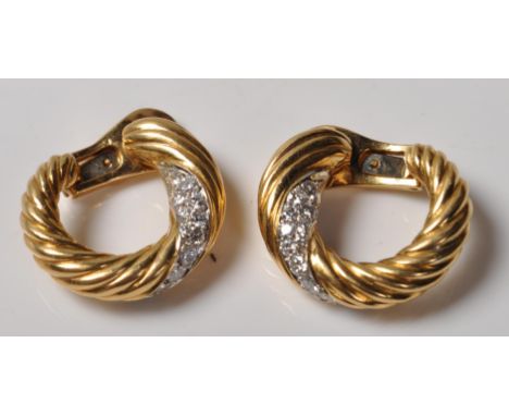 A pair of vintage retro 20th Century 18ct gold and diamond French clip on earrings on twisted knot design being set with roun