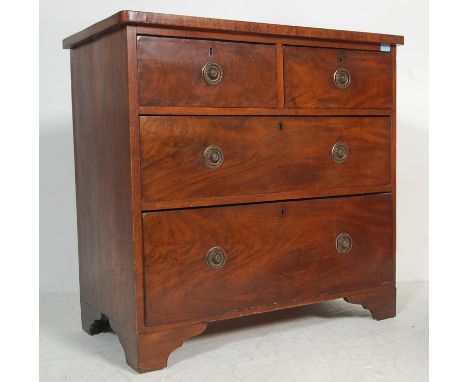 A 19th century Georgian mahogany chest of drawers having two short drawer over two long drawers with brass swing handles with