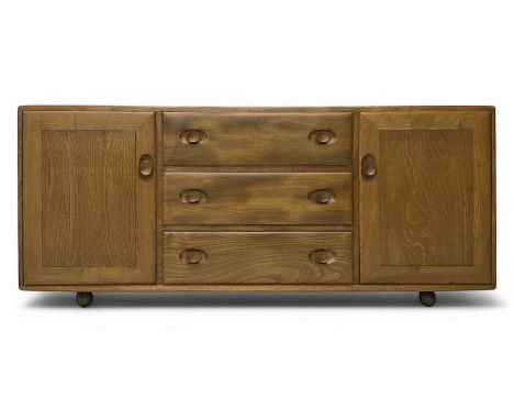 Lucian Ercolani for Ercol - elm sideboard, fitted with three drawers and flanking cupboards,on castors Dimensions:  Height: 6