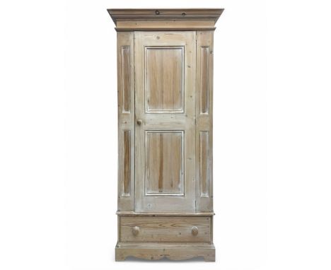 Victorian design lime-washed pine single wardrobe, projecting cornice over panelled door enclosing hanging rail, the lower se