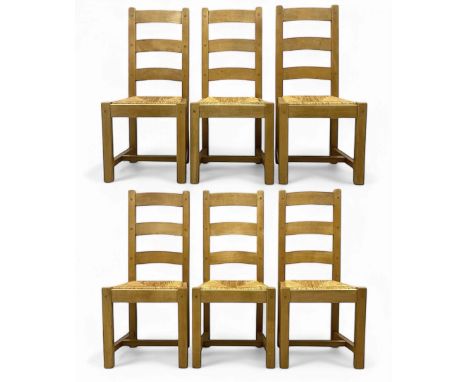 Set of six 20th century oak ladder-back dining chairs, pegged construction with rush seats, on square section supports united