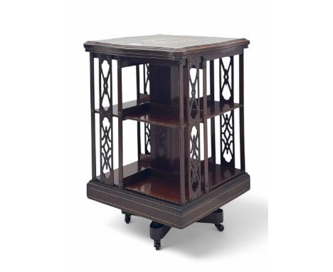 Edwardian inlaid mahogany revolving bookcase, shaped square moulded top with central motif and satinwood band, two tiers with