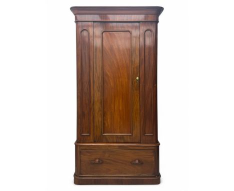 Large Victorian mahogany wardrobe, projecting moulded cornice over single panelled door enclosing hanging hooks and sliding r